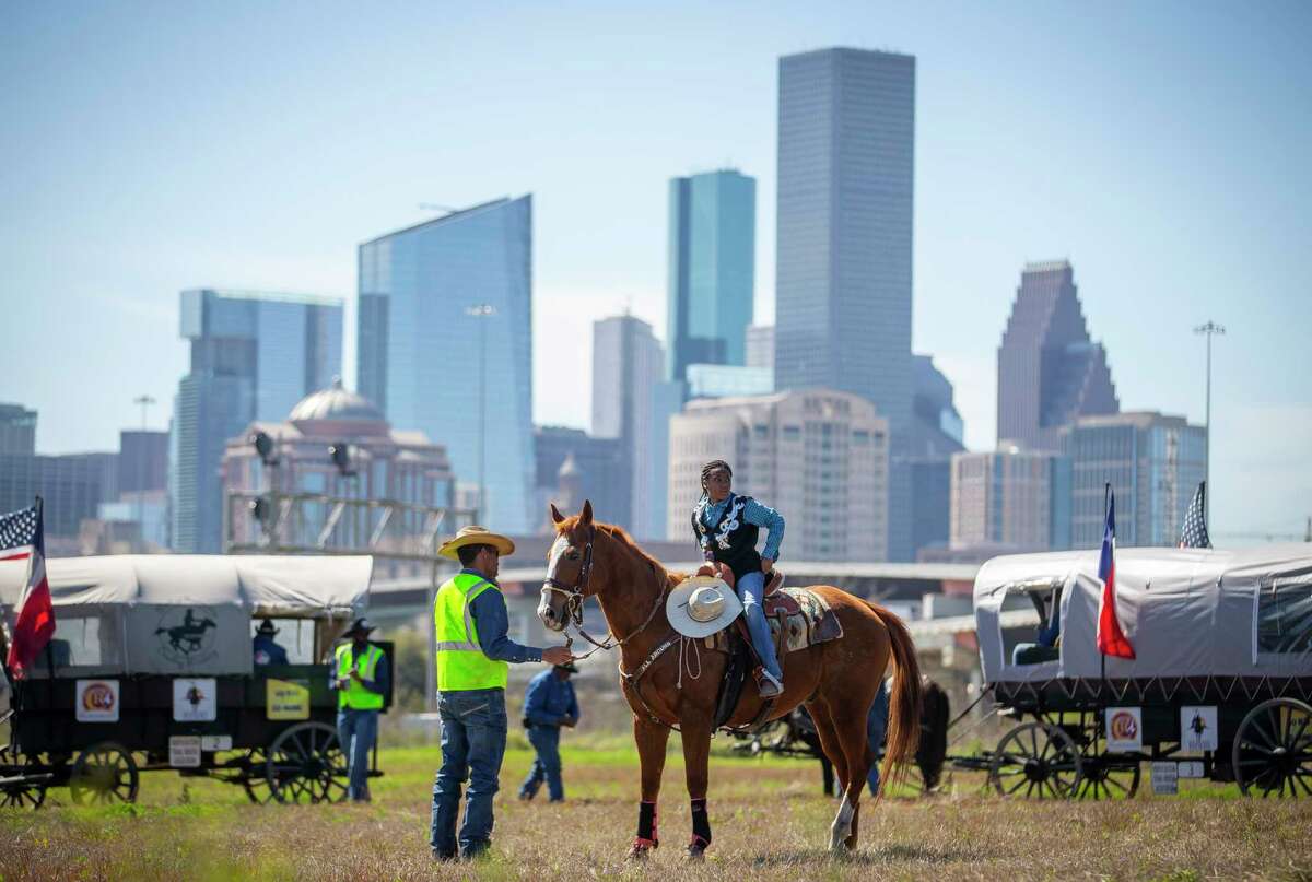 Riders with the Northeastern Trail Ride prepare to continue their ride after a lunch break on their final day of a seven-day-long trail ride that started near Beaumont, Friday, Feb. 28, 2020, in Houston.