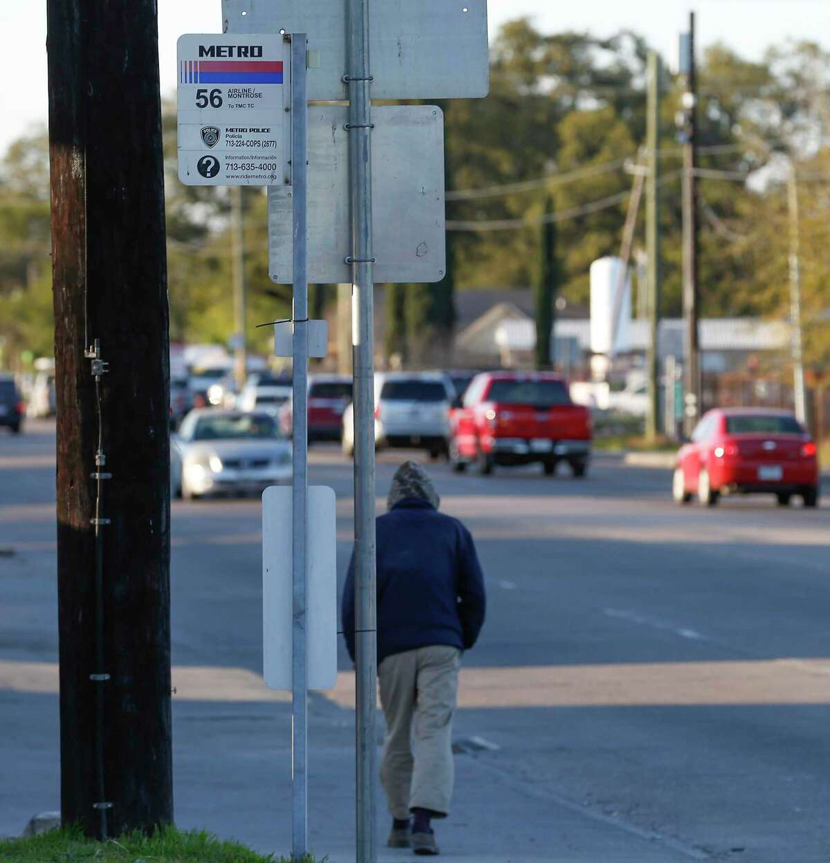 A pedestrian walks by a bus stop at Canino and Airline on Feb. 26, 2020, in Houston. Metropolitan Transit Authority is making changes to the 54 Scott and and 56 Montrose/Airline routes as the first steps to improve 17 corridors with better bus stops, access and traffic signal timing.