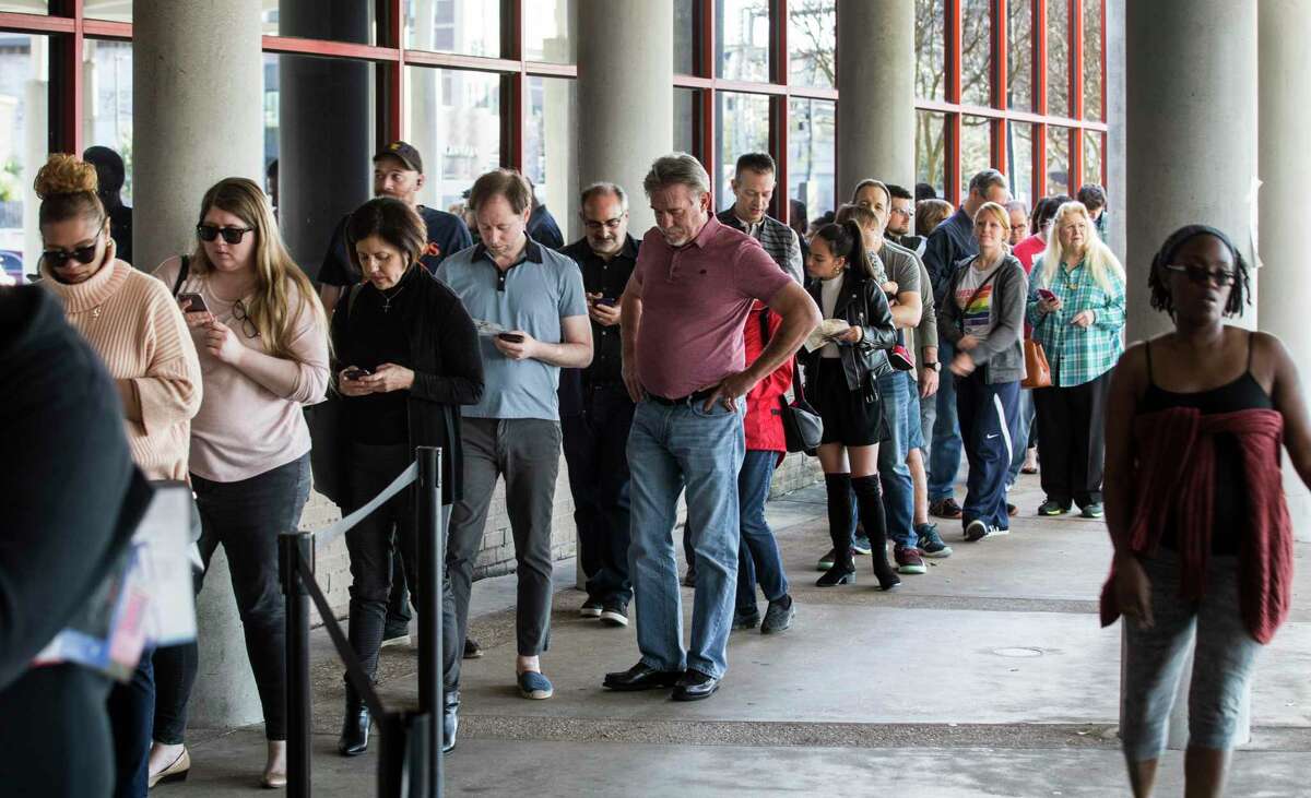 Voters line up outside the polling place in the Metropolitan Multi-Service Center to vote on the final day of early voting before the Super Tuesday primary election Friday, Feb. 28, 2020, in Houston.