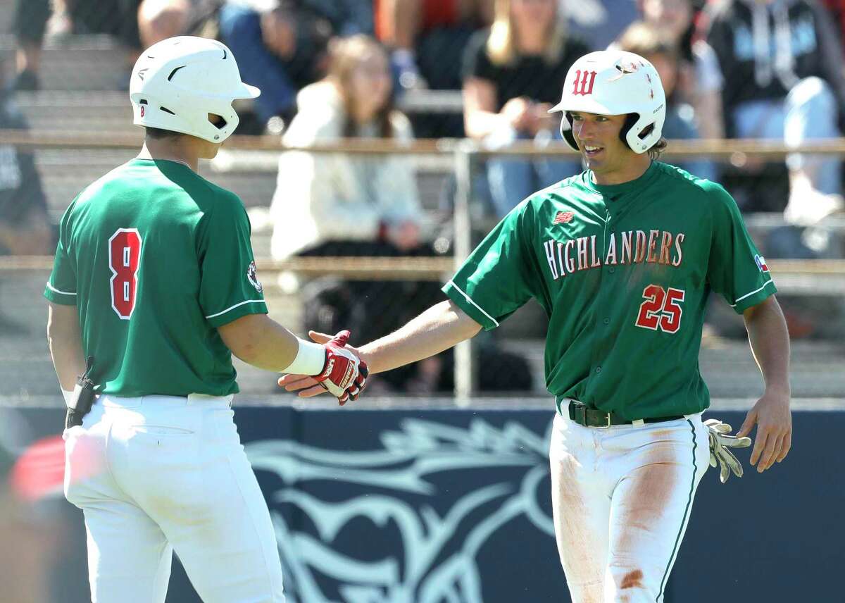 Matthew Bulovas #25 of The Woodlands gets a high-five from Drew Romo after scoring the go-head run off Will Thomas’s double during the sixth inning of a non-district high school baseball game at Kingwood High School, Friday, Feb. 28, 2020, in Kingwood.