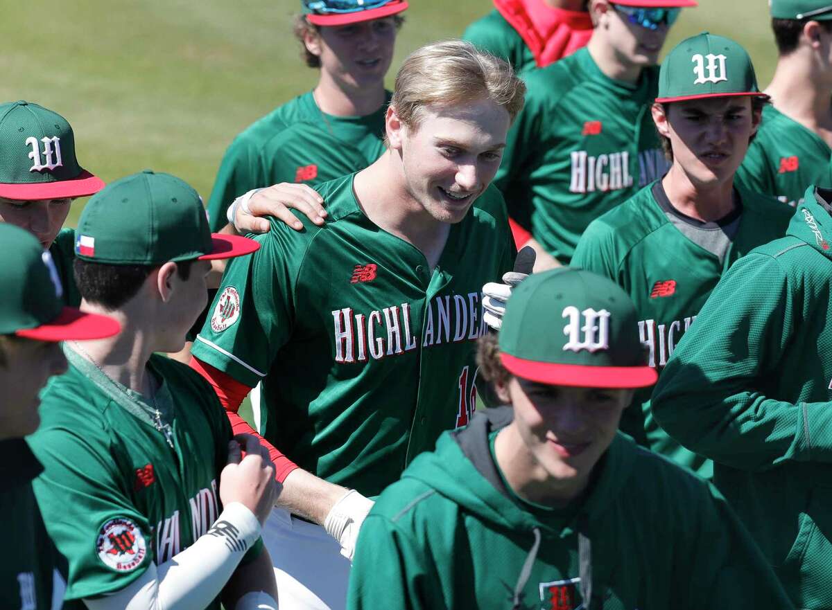 Justin Harris #16 of The Woodlands, center, reacts after hitting a solo home run to tie Kingwood 5-5 during the sixth inning of a non-district high school baseball game at Kingwood High School, Friday, Feb. 28, 2020, in Kingwood.