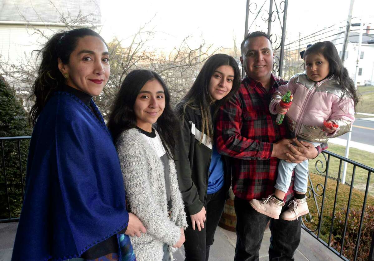 Gabriela Ramon, left, Subhadra Pesantez, 13, Cristina Pesantez, 16, Tito Pesantez and Vrindavana Pesantez, right, at their home. Gabriela Ramon's daughters Subhadra, 13, and Cristina Pesantez, 16, have gone to AIS for elementary school and Westside Middle School Academy, both magnet schools. Ramon has helped others with the lottery process. Friday, February 28, 2020, in Danbury, Conn.