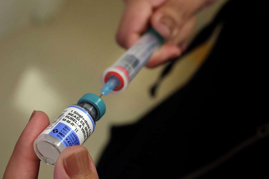 A vial containing the MMR vaccine is loaded into a syringe. Photo: Mel Melcon / TNS / Los Angeles Times