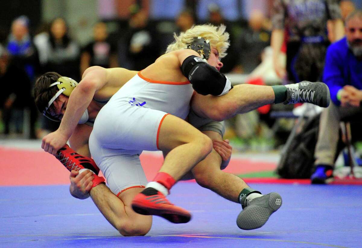 Danbury’s Ryan Jack wrestles against Bristol Eastern’s Thomas Nichols during CIAC State Open in New Haven on Saturday. Danbury won its fourth consecutive title.