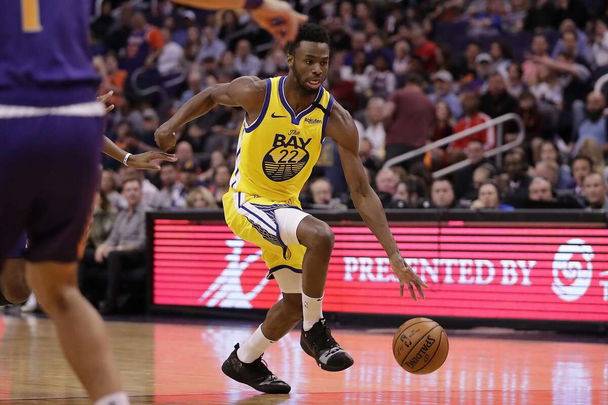 Golden State Warriors guard Andrew Wiggins (22) against the Phoenix Suns during the first half of an NBA basketball game Saturday, Feb. 29, 2020, in Phoenix. (AP Photo/Matt York)