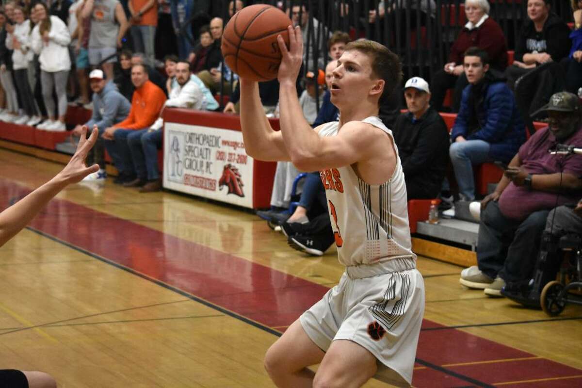 Ridgefield’s Johnny Briody takes a shot during the FCIAC quarterfinals at Fairfield Warde on Saturday, Feb. 29, 2020.