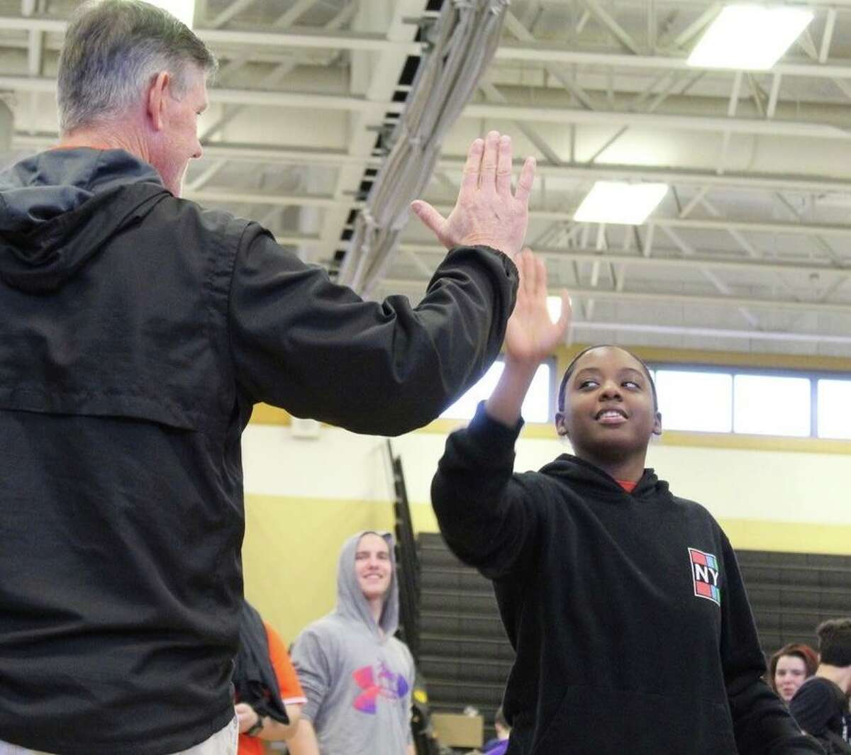 Anala Smith is greeted by Shelton wrestling coach Bill Maloney.