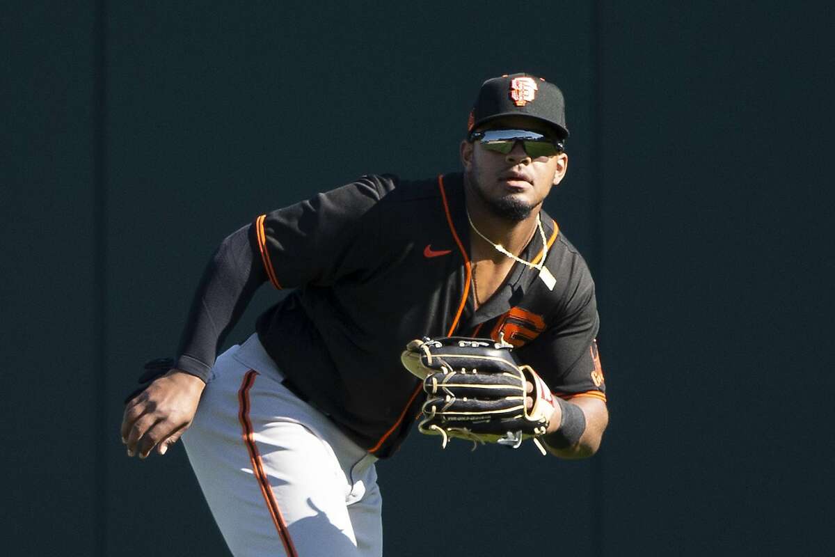 GLENDALE, ARIZONA - FEBRUARY 25: Heliot Ramos #80 of the San Francisco Giants fields against the Chicago White Sox on February 25, 2020 at Camelback Ranch in Glendale Arizona. ~~