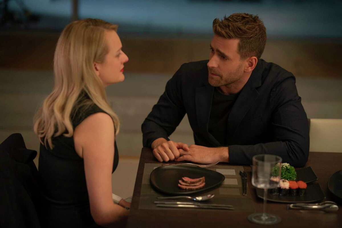 This image released by Universal Pictures shows Elisabeth Moss, left, and Oliver Jackson-Cohen in a scene from