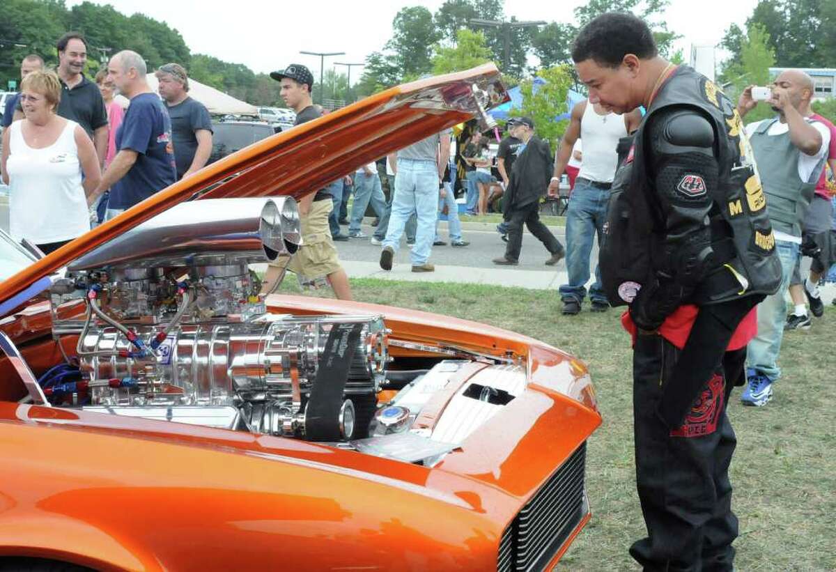 Kyle Smith of Bridgeport looks at a custom engine in a Charger at the 4th Annual Cruzin New Milford 2010 Car and Motorcycle Night on Sunday Aug. 15, 2010 at Faith Church in New Milford.