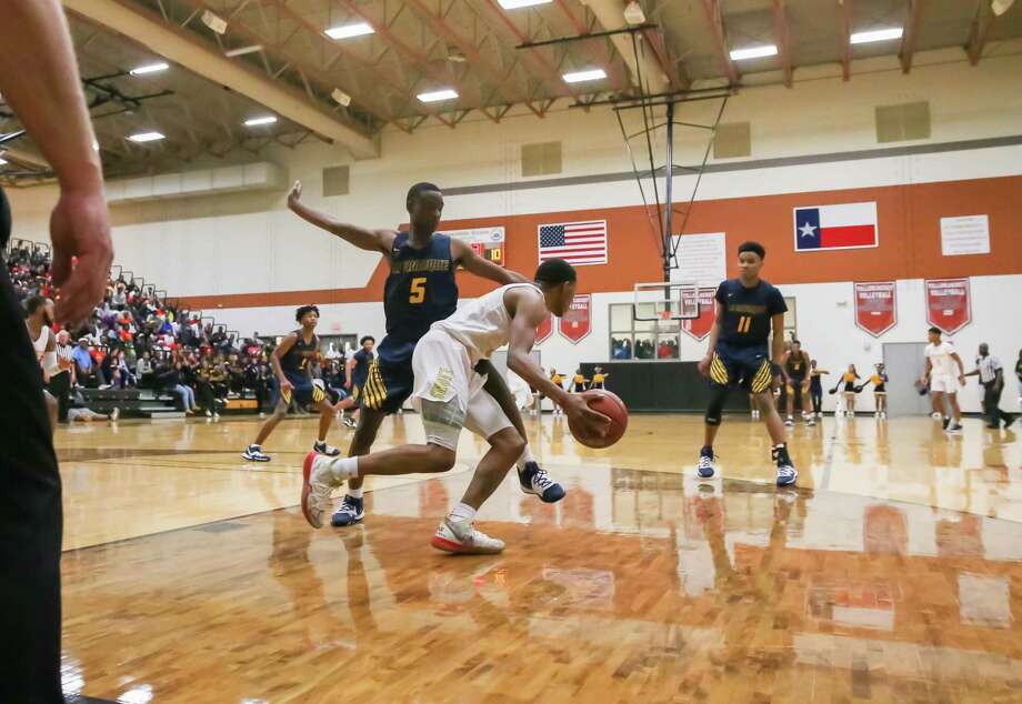 Yates Elijah Elliott (11) drives the ball past La Marque Frezno Bell (5) in the first quarter of the La Marque vs Yates boys' basketball Regional Quarter Final game on at Alvin High School Field House on March 2, 2020 in Alvin, TX. Photo: Leslie Plaza Johnson, Contributor / Houston Chronicle