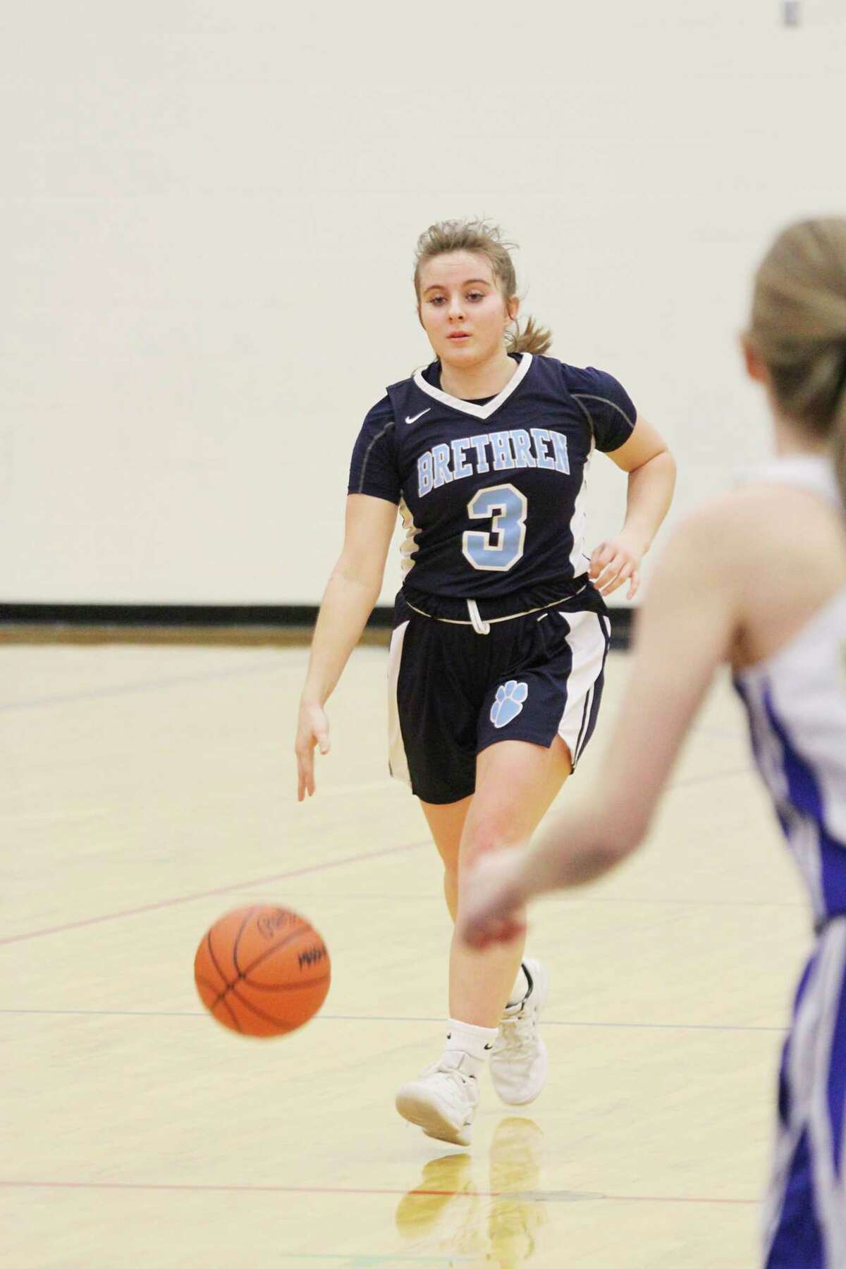 Brethren's Megan Cordes dribbles down the court during the Bobcats' district loss to Onekama. (Dylan Savela/News Advocate)
