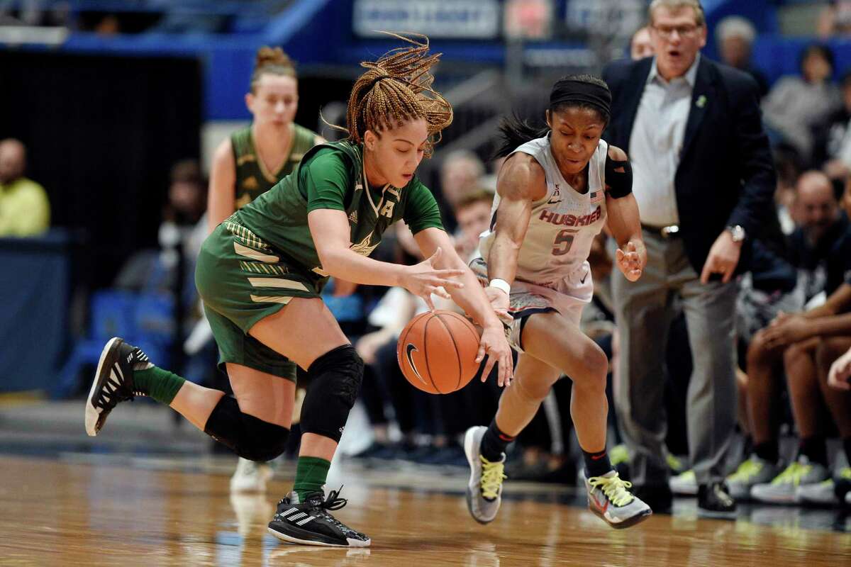 Connecticut's Crystal Dangerfield, right, pressures South Florida's Elena Tsineke in the first half of an NCAA college basketball game, Monday, March 2, 2020, in Hartford, Conn. (AP Photo/Jessica Hill)