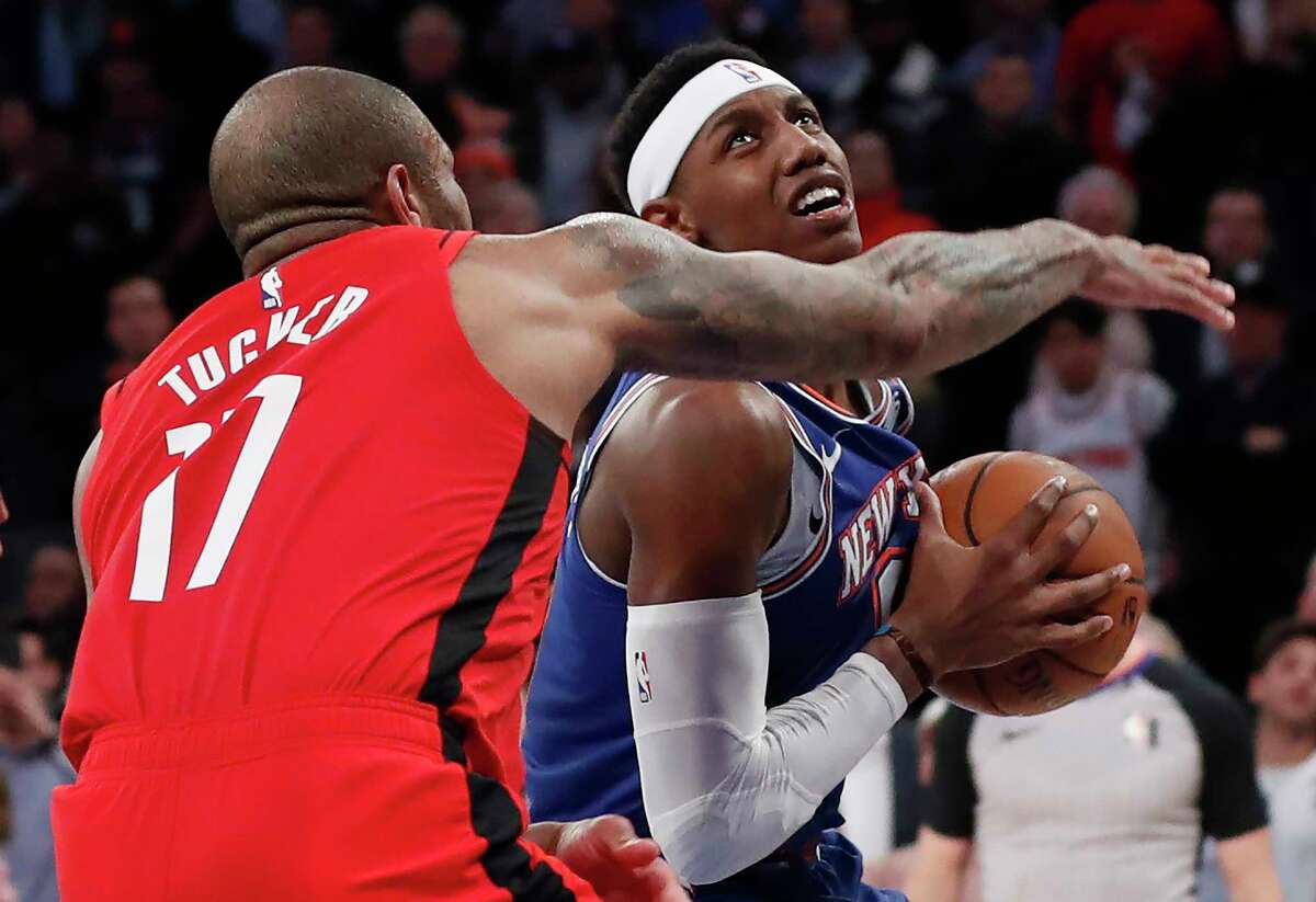 Houston Rockets forward P.J. Tucker (17) defends against New York Knicks guard RJ Barrett, right, who looks toward the basket during the waning seconds of the fourth quarter of an NBA basketball game in New York, Monday, March 2, 2020. Barrett made a basket to preserve a Knicks' lead in the team's win. (AP Photo/Kathy Willens)