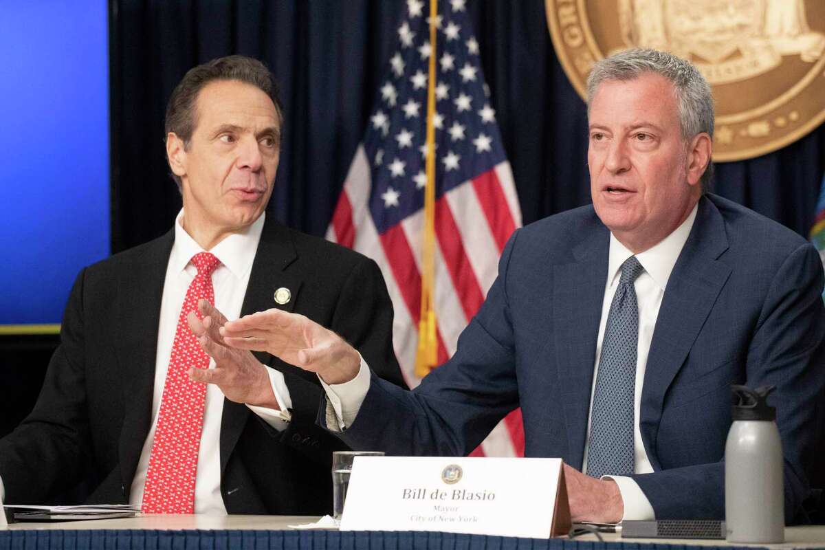 New York Gov. Andrew Cuomo, left, and Mayor Bill de Blasio discuss the state and city's preparedness for the spread of coronavirus at a news conference, Monday, March 2, 2020 in New York. (AP Photo/Mark Lennihan)
