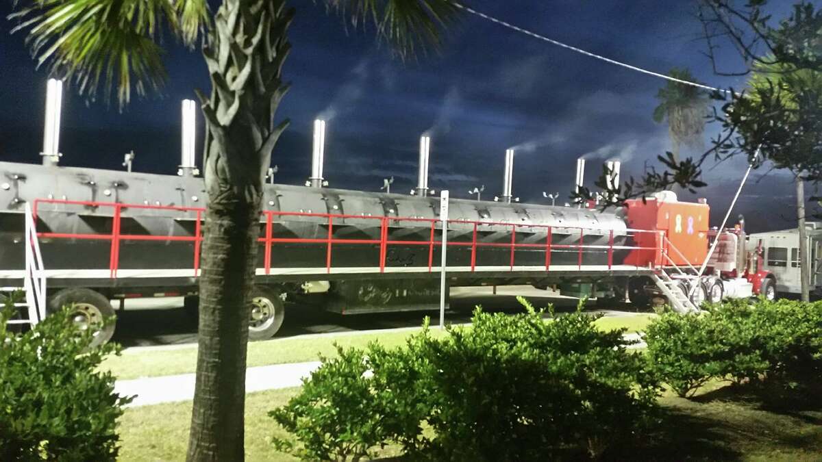 The rig is 76-foot long, and weighs 80,000 lbs. Terry Folsom said the barbecue grill/pit trailer is the largest mobile smoker in the world. The custom-made trailer was built in 2000, has 24 smoking compartments and a firebox in the shape of the state of Texas at the rear.