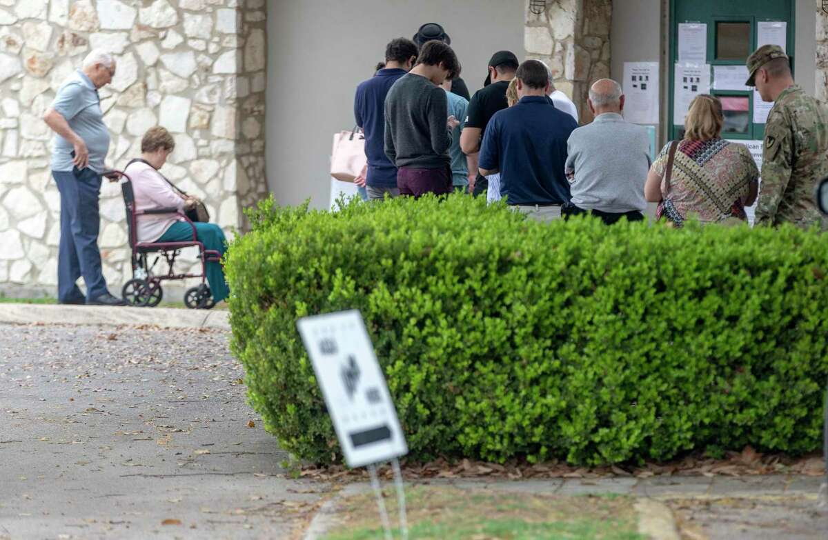 People wait in line to vote in the Super Tuesday primaries at the Lions Field Adult and Senior Center.