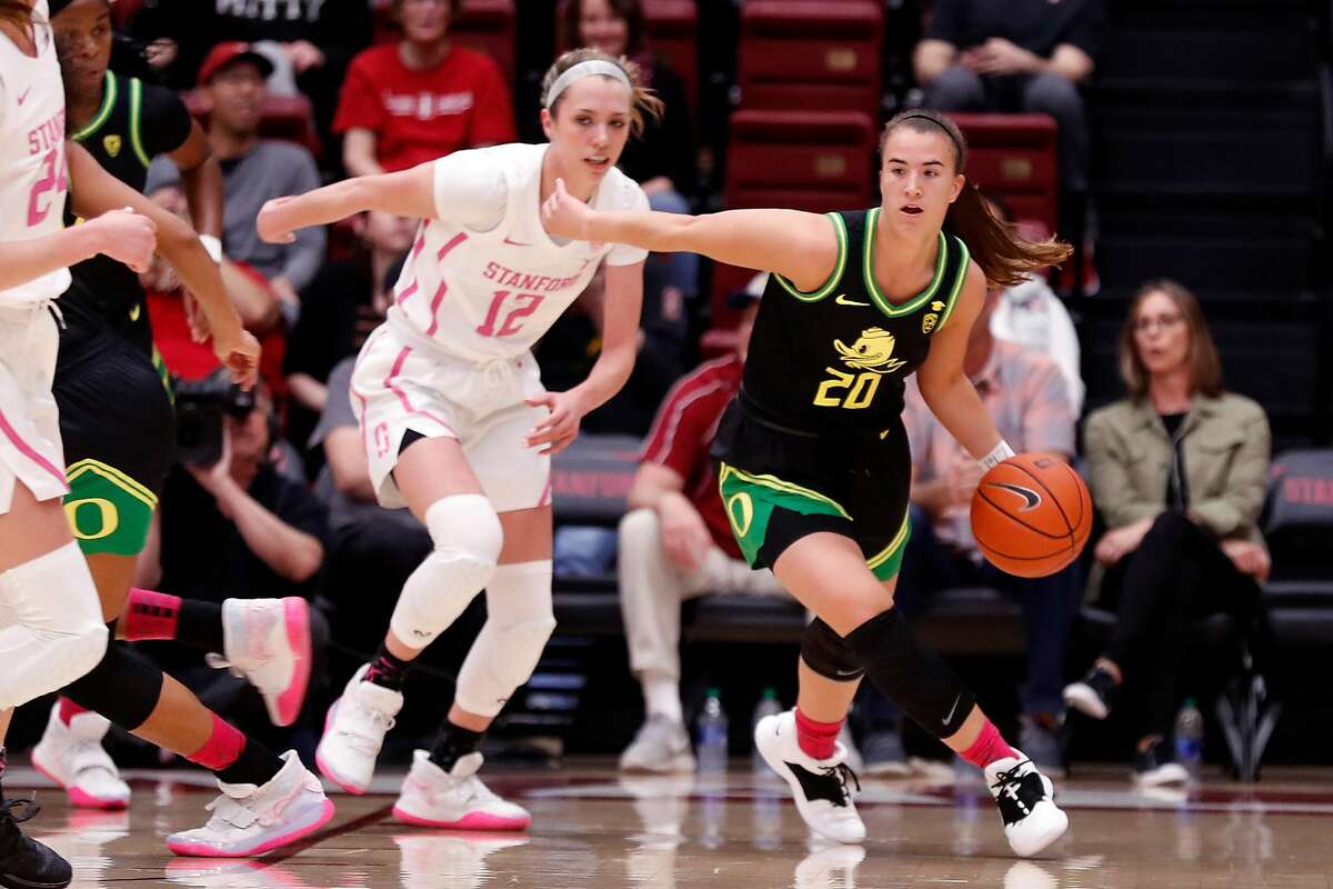 Oregon"s Sabrina Ionescu dribbles up court in front of Stanford's Lexie Hull during Pac 12 women's basketball game at Maples Pavilion in Stanford, Calif., on Monday, February 24, 2020.