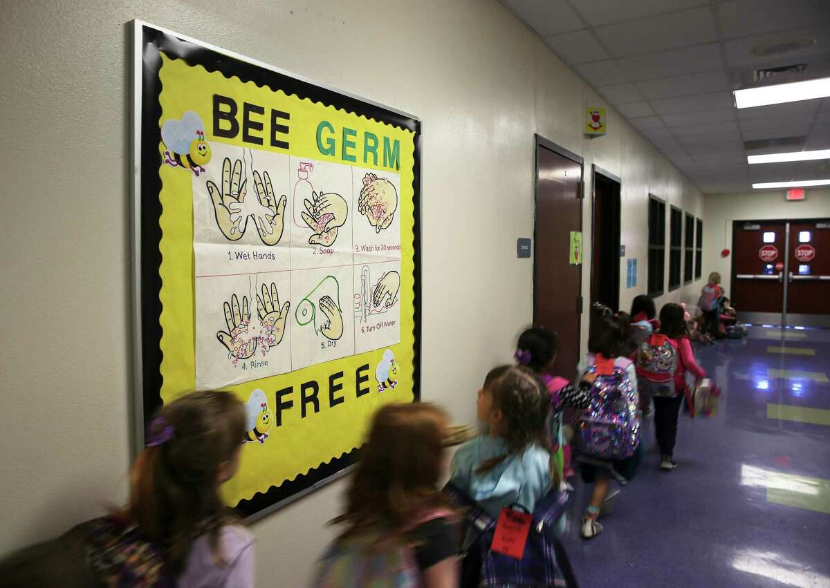As the coronavirus pandemic loomed in early March, Oak Crest Elementary in East Central ISD posted signs in restrooms and one in the main hallway to remind students about proper hand washing. School districts will be allowed to delay reopening this fall due to the pandemic if local health authorities order it.