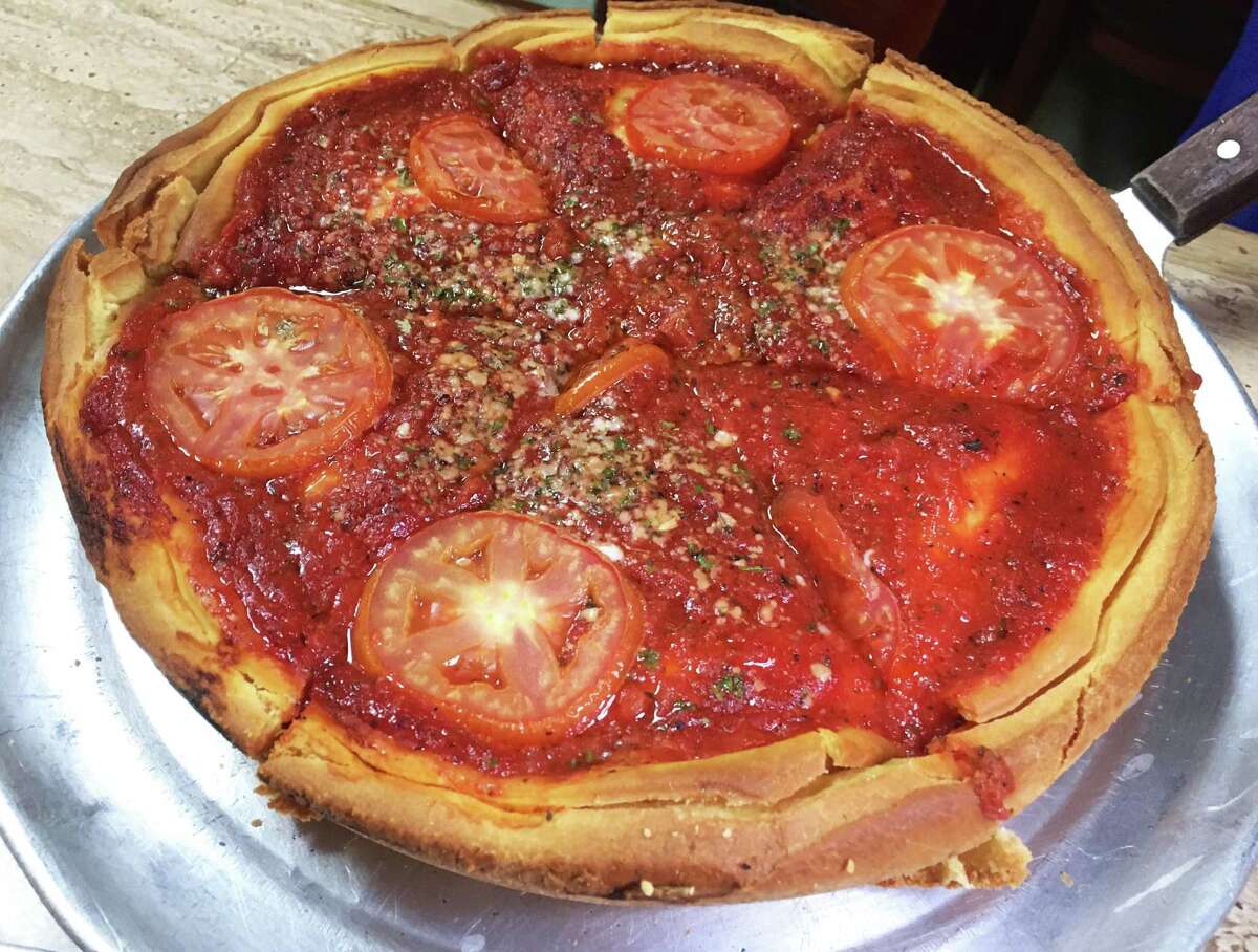 The Chicago-style pizza at Chicago's Pizza with pepperoni, sausage, green peppers and sliced tomatoes is served in thick slices.