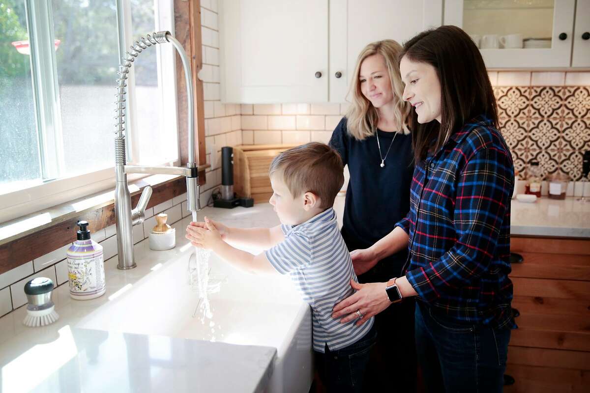 Naomi Thorne, right, and Katherine Thorne help heir 2-year-old son Everett wash his hands at their home in Novato, California, Tuesday, March 3, 2020. The family is taking precautionary actions to ward off the novel coronavirus. Ramin Rahimian/Special to The Chronicle