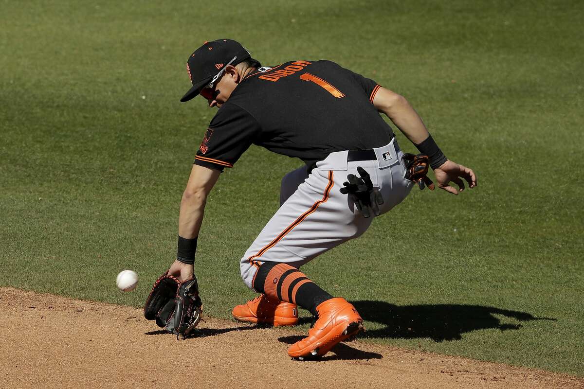 San Francisco Giants second baseman Mauricio Dubon fields a ground out hit into by San Diego Padres' Tommy Pham during the fourth inning of a spring training baseball game Sunday, March 1, 2020, in Peoria, Ariz. (AP Photo/Charlie Riedel)