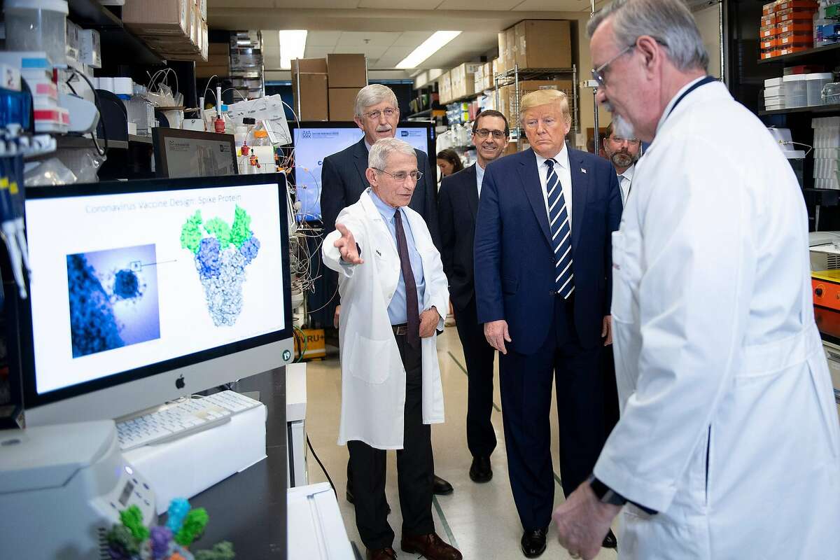 National Institute of Allergy and Infectious Diseases Director Tony Fauci (left) speaks to President Donald Trump during a tour of the National Institutes of Health's Vaccine Research Center on March 3, 2020, in Bethesda, Md,