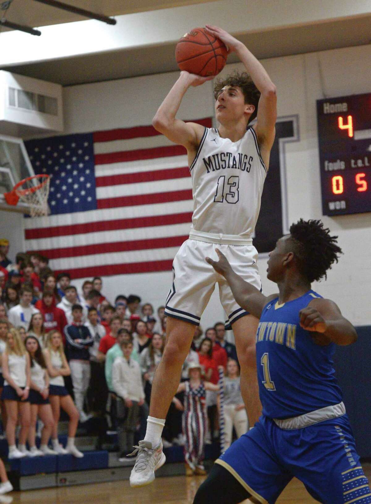Immaculate's Sebastian Parenti (13) shoots over Newtown's Tyson Mobley (1) in the SWC boys basketball semifinal between No.4 Newtown and No.1 Immaculate, Tuesday night, March 3, 2020, at Immaculate High School, Danbury, Conn.