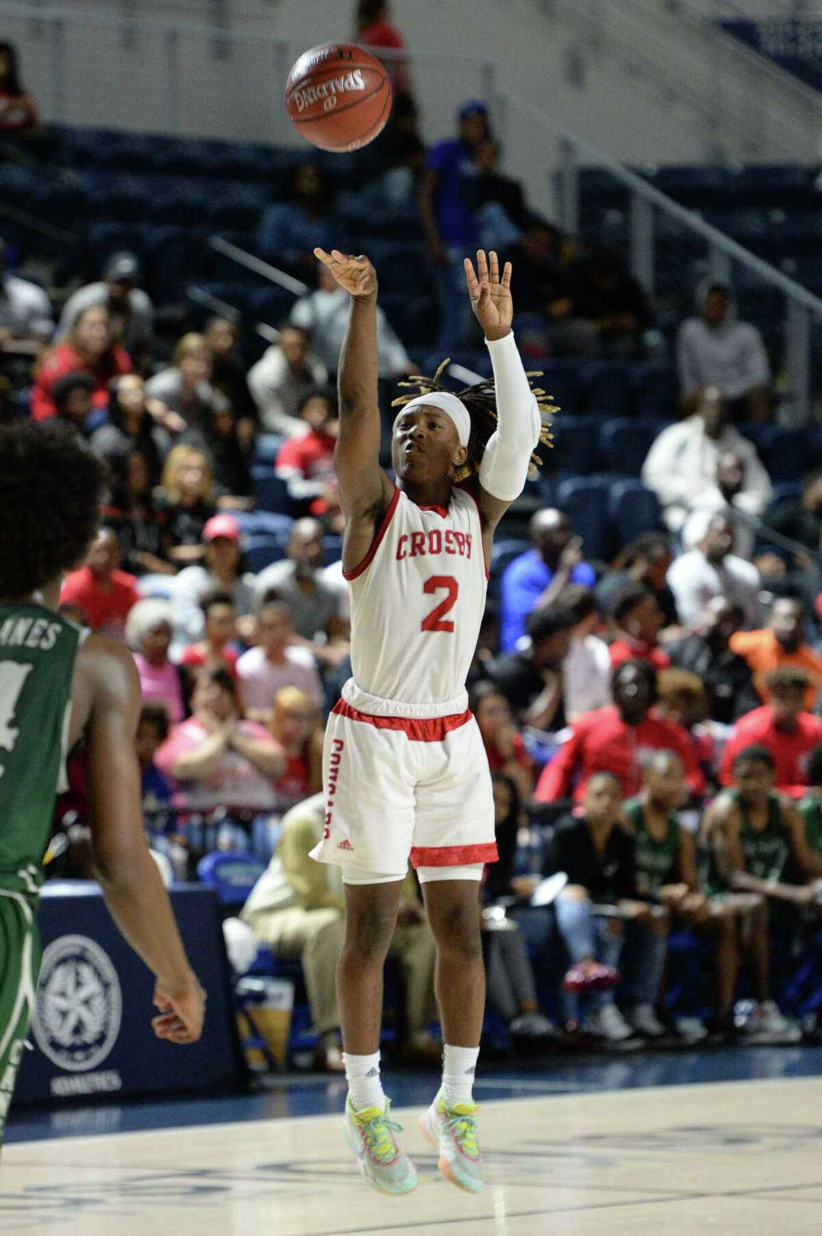 Deniquez Dunn (2) of Crosby attempts a jump shot during the fourth quarter of the Boys 5A Region III Quarterfinal basketball game between the Hightower Hurricanes and the Crosby Cougars on Tuesday, March 3, 2020 at Delmar Fieldhouse, Houston, TX.