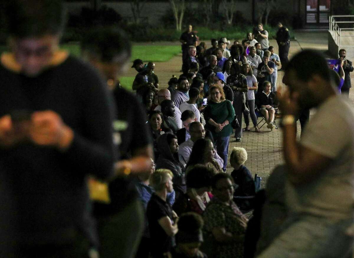 People wait in line to vote around 9:45 p.m. Tuesday, March 3, 2020, at Texas Southern University in Houston.