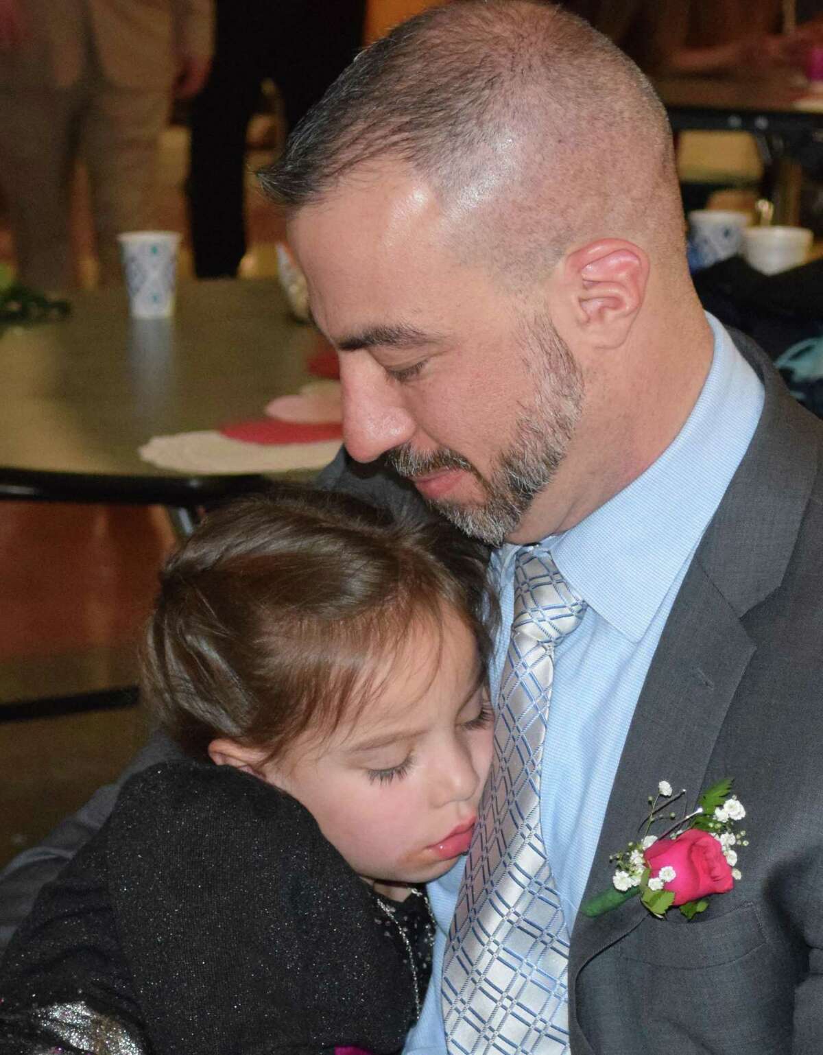 Spectrum/New Milford Girl Scout Troop 40270 hosted the annual Sweetheart Dance at New Milford High School Feb. 22, 2020.The event featured formal photos, a silent auction, dancing, refreshments and more. Above, Harper Allen, 5, of New Milford takes a brief nap on her father, Tom's, lap.