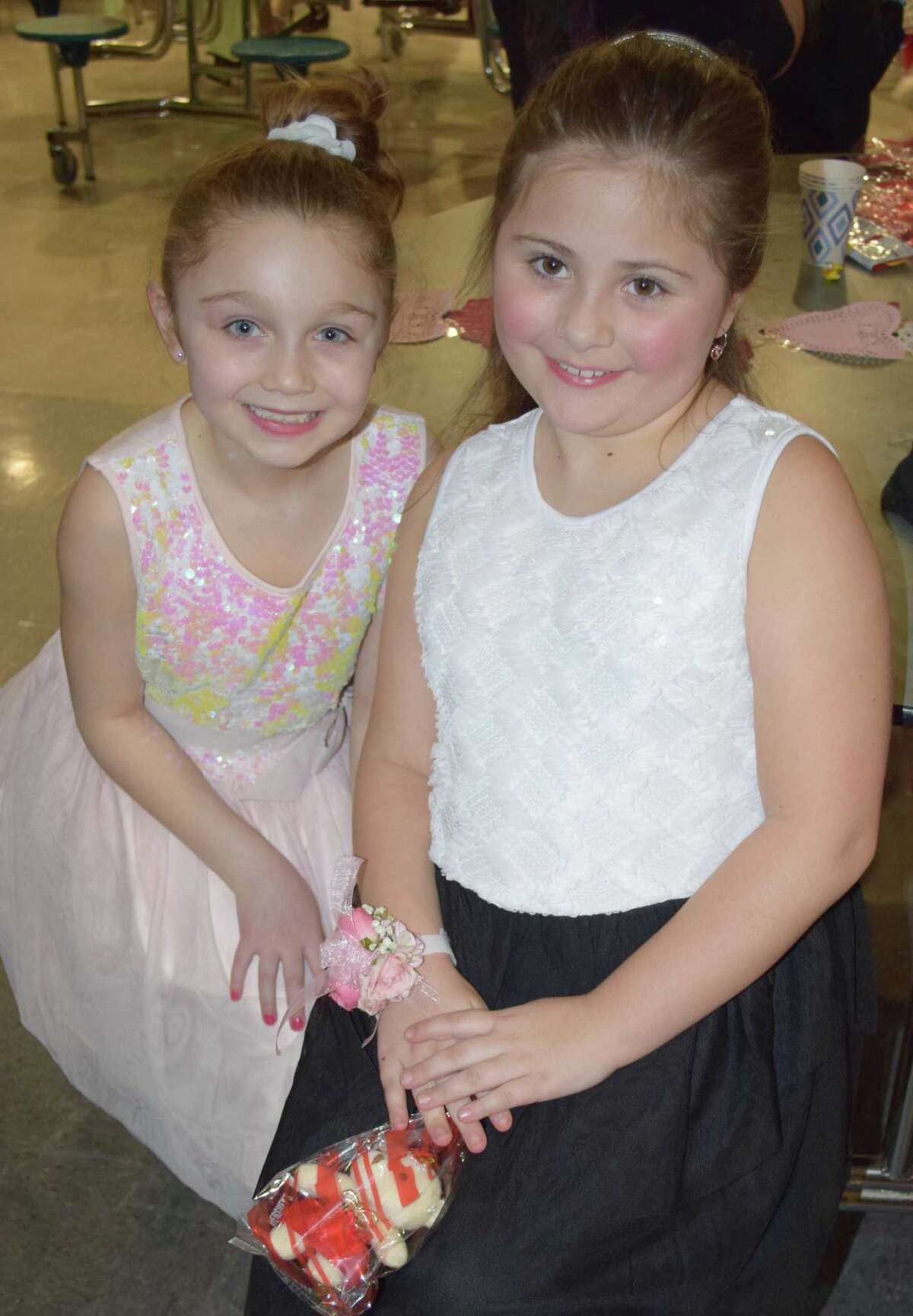 Spectrum/New Milford Girl Scout Troop 40270 hosted the annual Sweetheart Dance at New Milford High School Feb. 22, 2020.The event featured formal photos, a silent auction, dancing, refreshments and more. Above, friends Jenna Panepento, 9, left, and Sophia Turco, 8, of New Milford ham it up for the camera.