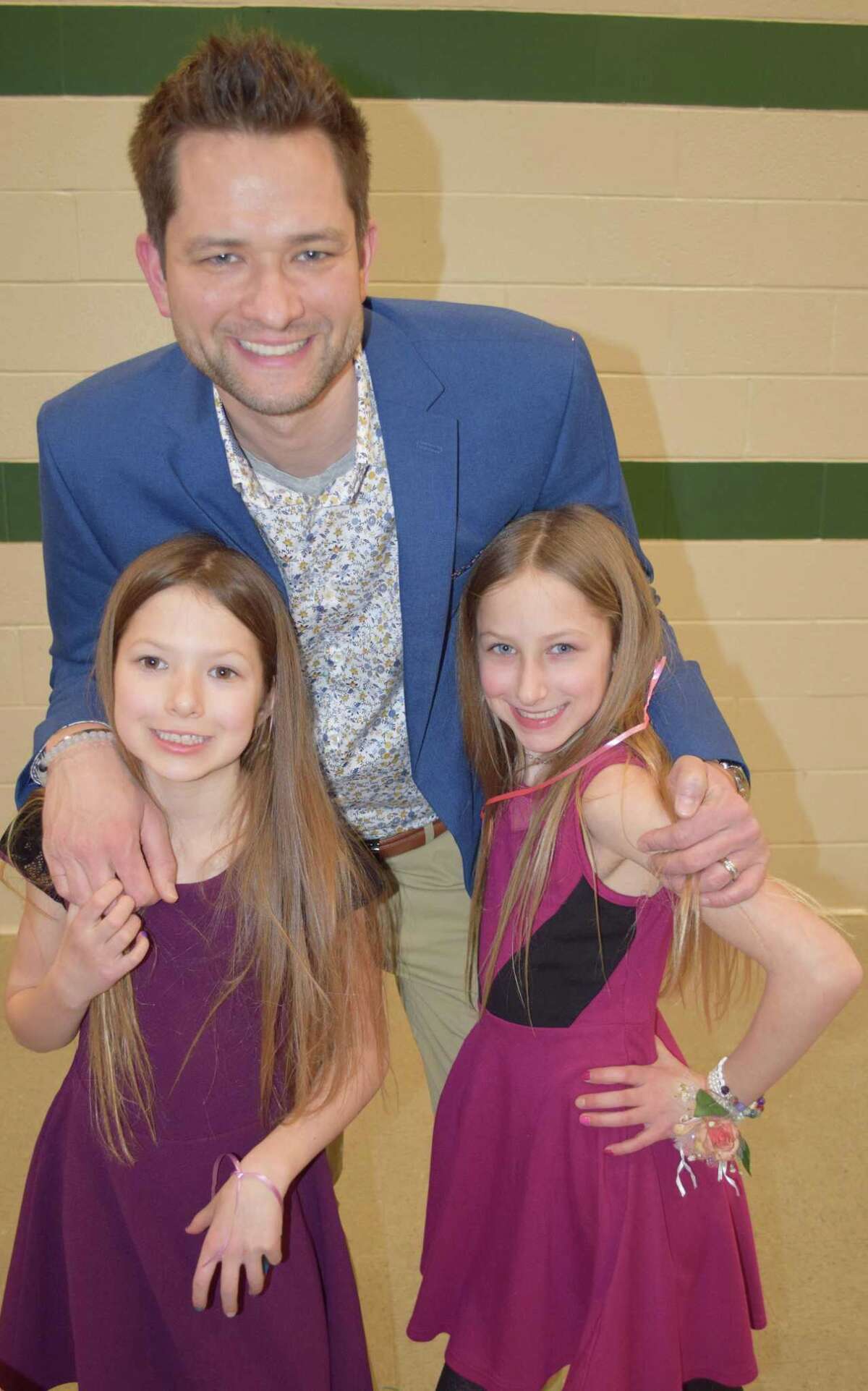 Spectrum/New Milford Girl Scout Troop 40270 hosted the annual Sweetheart Dance at New Milford High School Feb. 22, 2020.The event featured formal photos, a silent auction, dancing, refreshments and more. Above, Joe Bittner and his twin daughters, Briella, left, and Haley, 8, ham it up for the camera after wrapping up their night at the dance.