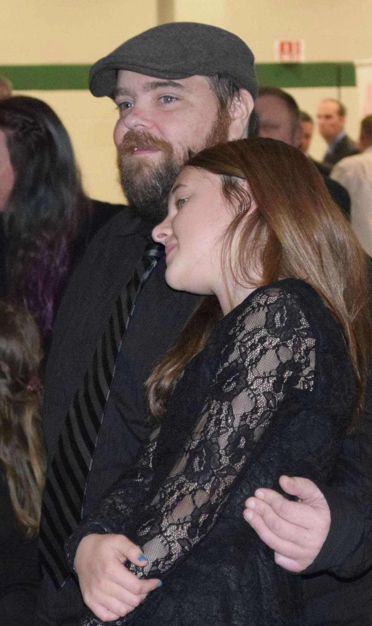 Ava Baldwin, 11, of New Milford and her father, Billy, share a quiet moment together as they watch others on the dance floor.