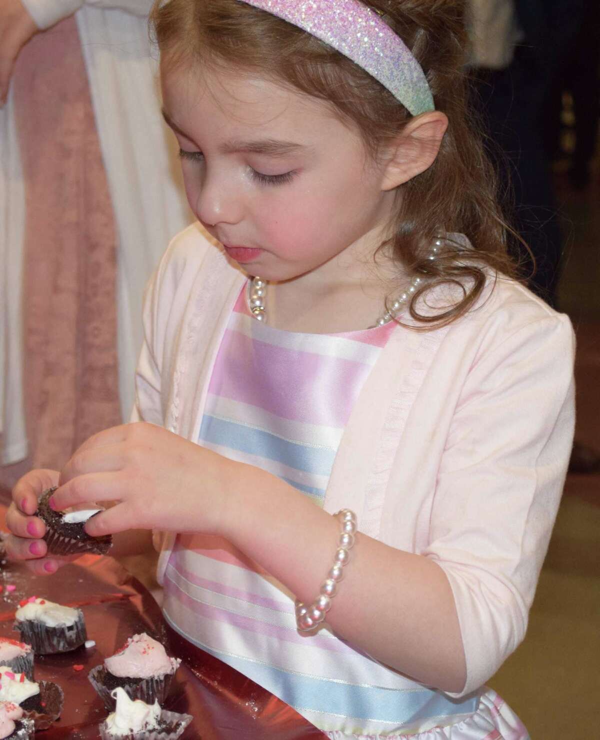Reagan Lawler, 5, of New Milford makes a last stop at the refreshment table before the last dance.