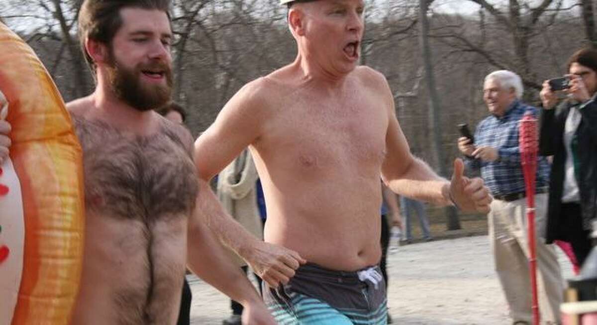 Doug Bogan, left, and Bob McDowell run toward Kiwanis Pond at the Riverbrook Regional YMCA in Wilton for the annual Swamp Romp last year. This year’s polar plunge will be on March 7.