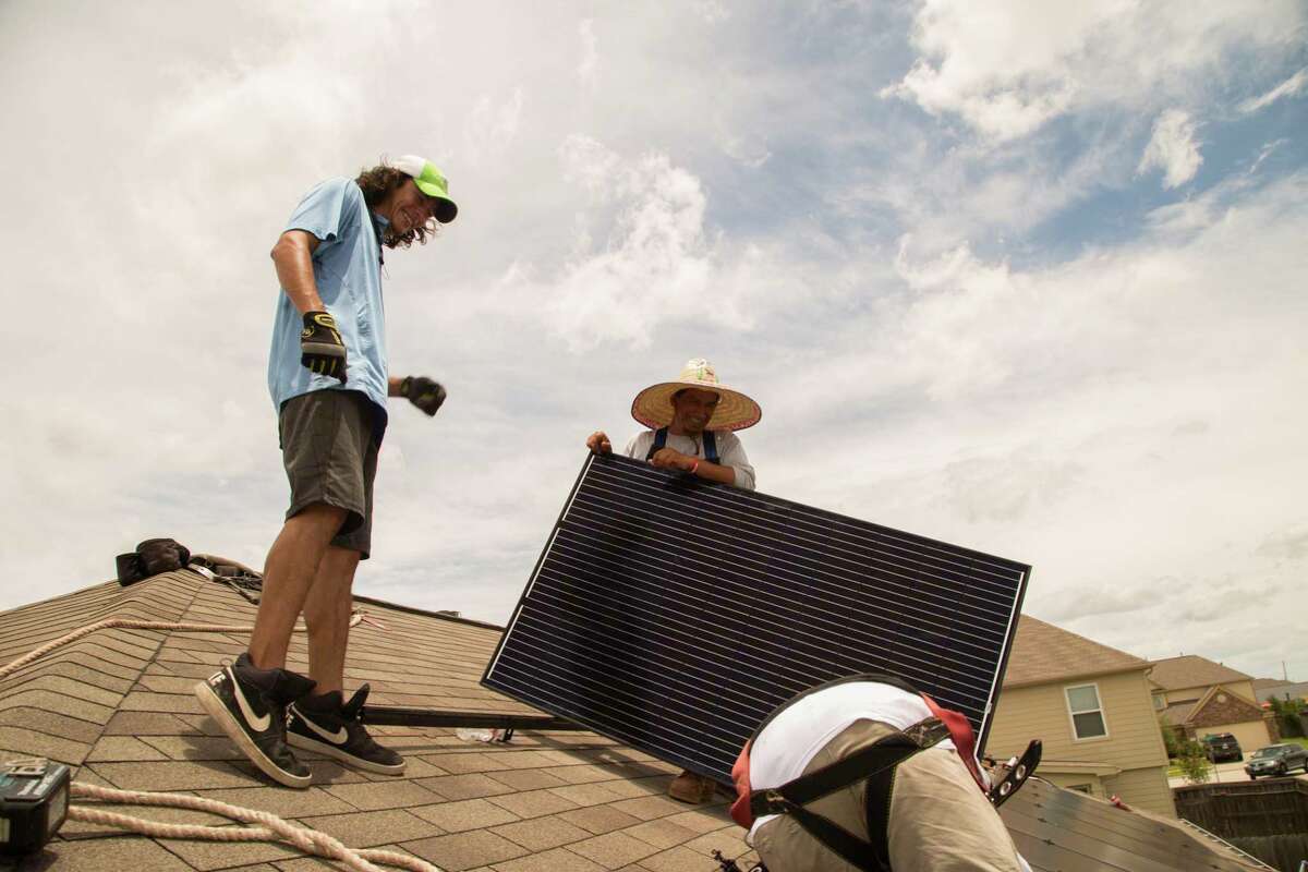 Workers install solar panels on a home in Katy in 2017. Texas is a leader in wind, oil and gas production, and the time has come to lead on solar, too.
