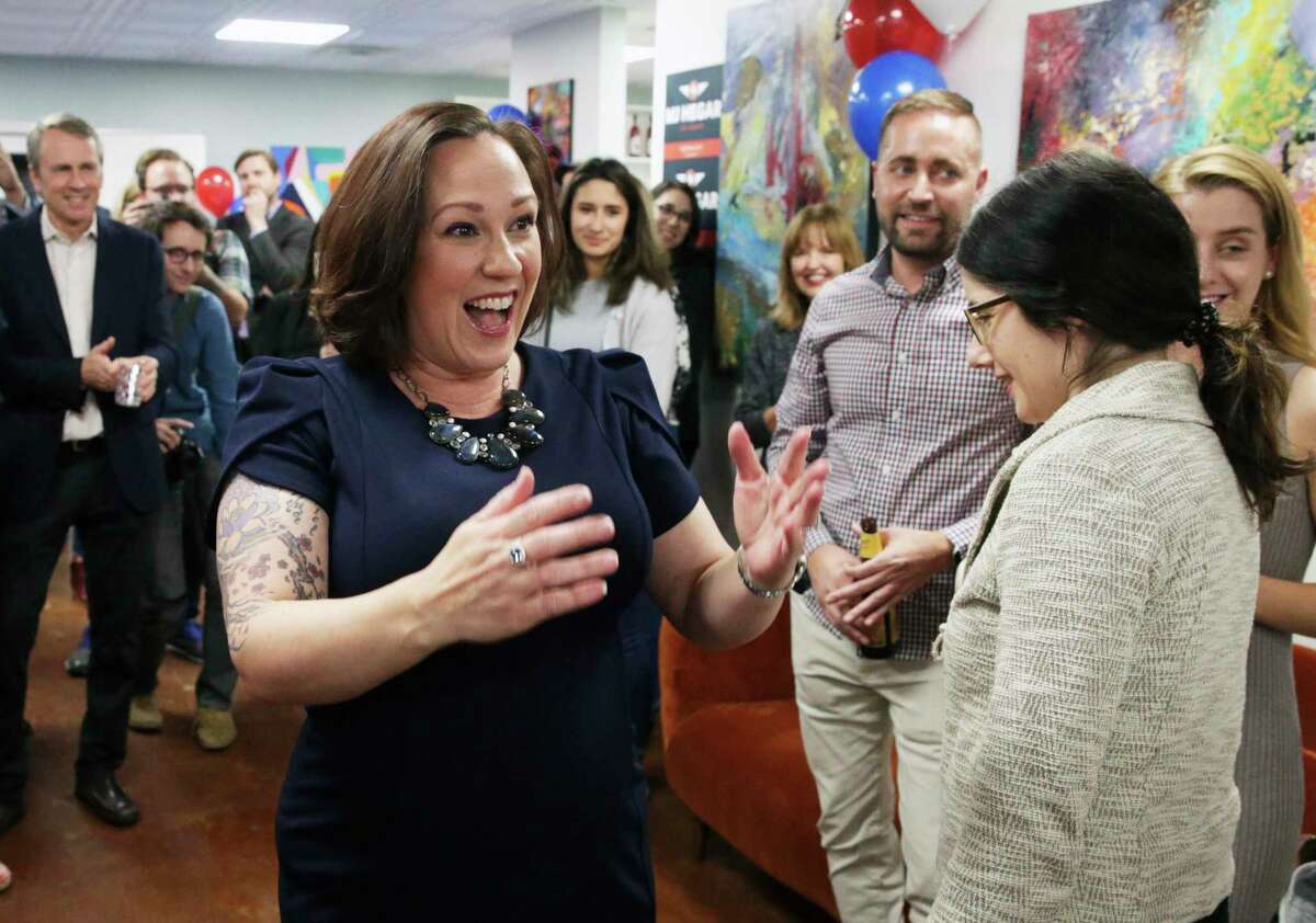 Democratic U.S. Senate candidate MJ Hegar visits with her supporters after the polls close at the offices of The Riveter in Austin on Feb. 2, 2020.