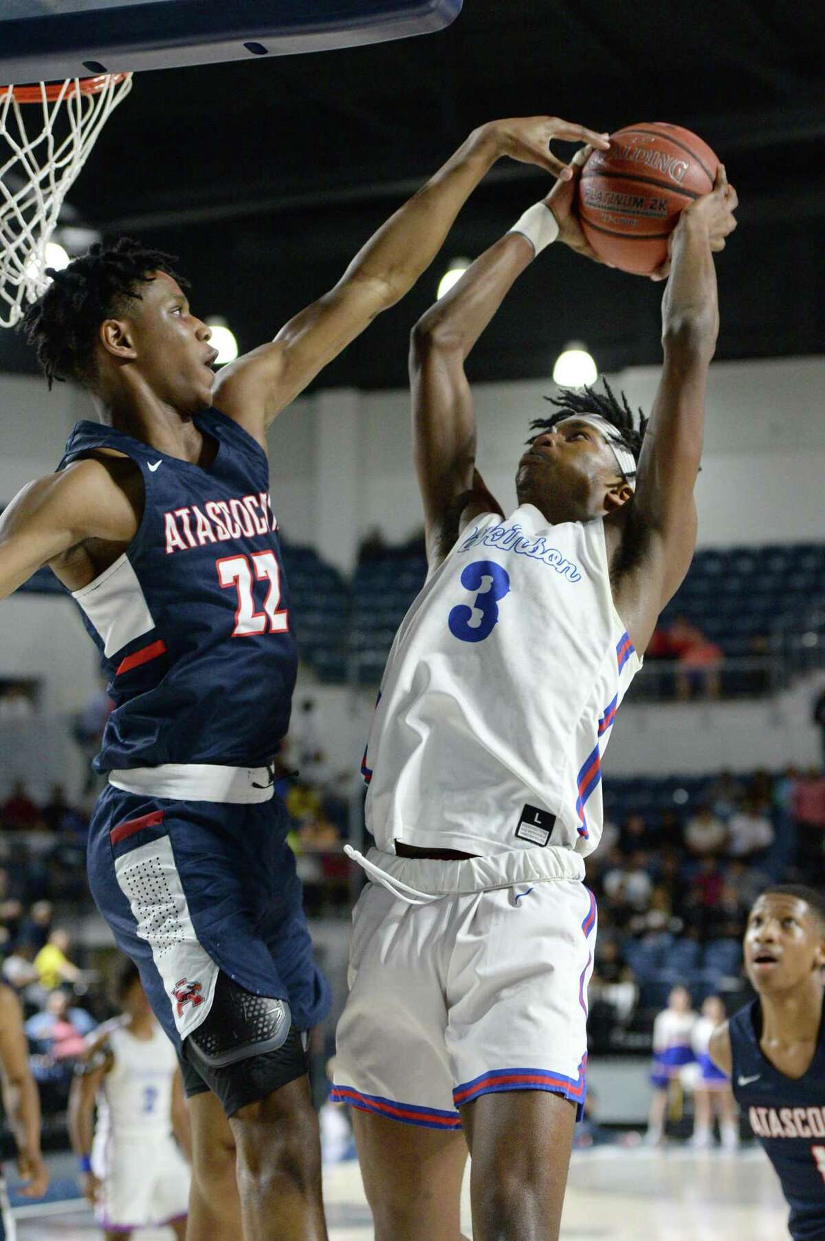 Cameron Morrison (22) of Atascocita attempts to block the shot of Tramon Mark (3) of Dickinson during the second quarter of the Boys 6A Region III Quarterfinal basketball game between the Dickinson Gators and the Atascocita Eagles on Tuesday, March 3, 2020 at Delmar Fieldhouse, Houston, TX.
