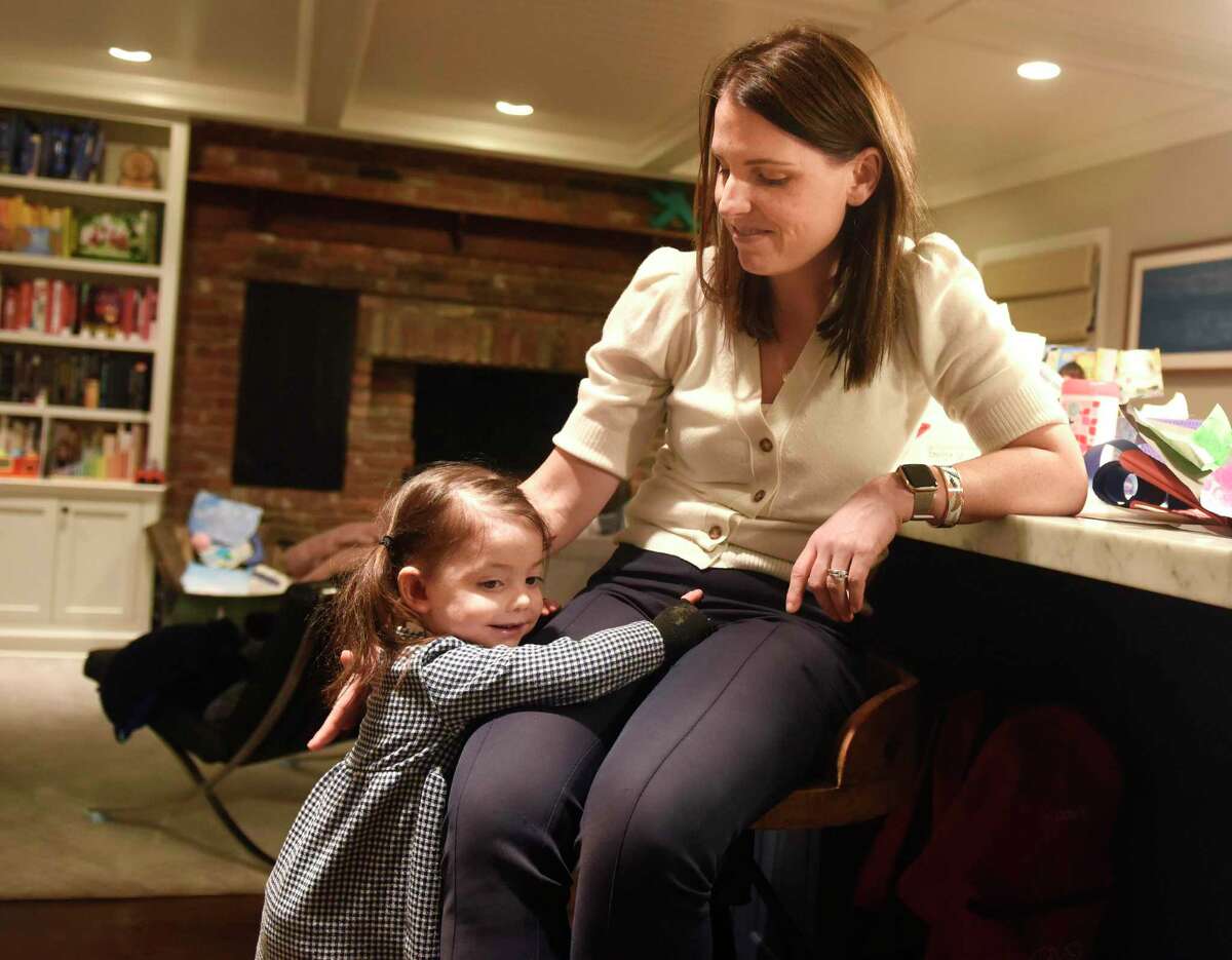 Elodie Kubik, 3, hugs her mother, Emily Kubik, at their Riverside home on Tuesday. Elodie was born with a rare genetic condition called epidermolysis bullosa, which causes fragile skin that can be wounded and break open during normal daily activities. The life expectancy for those with Elodie's type of EB is just 30 years. The family has an annual fundraiser, the Plunge For Elodie, and for the first time, they're hosting a plunge in Old Greenwich at Lucas Point Beach on March 8 at 8 a.m. There will be other plunges that same weekend in Boston, San Francisco, London and Staten Island with a goal of raising $250,000.