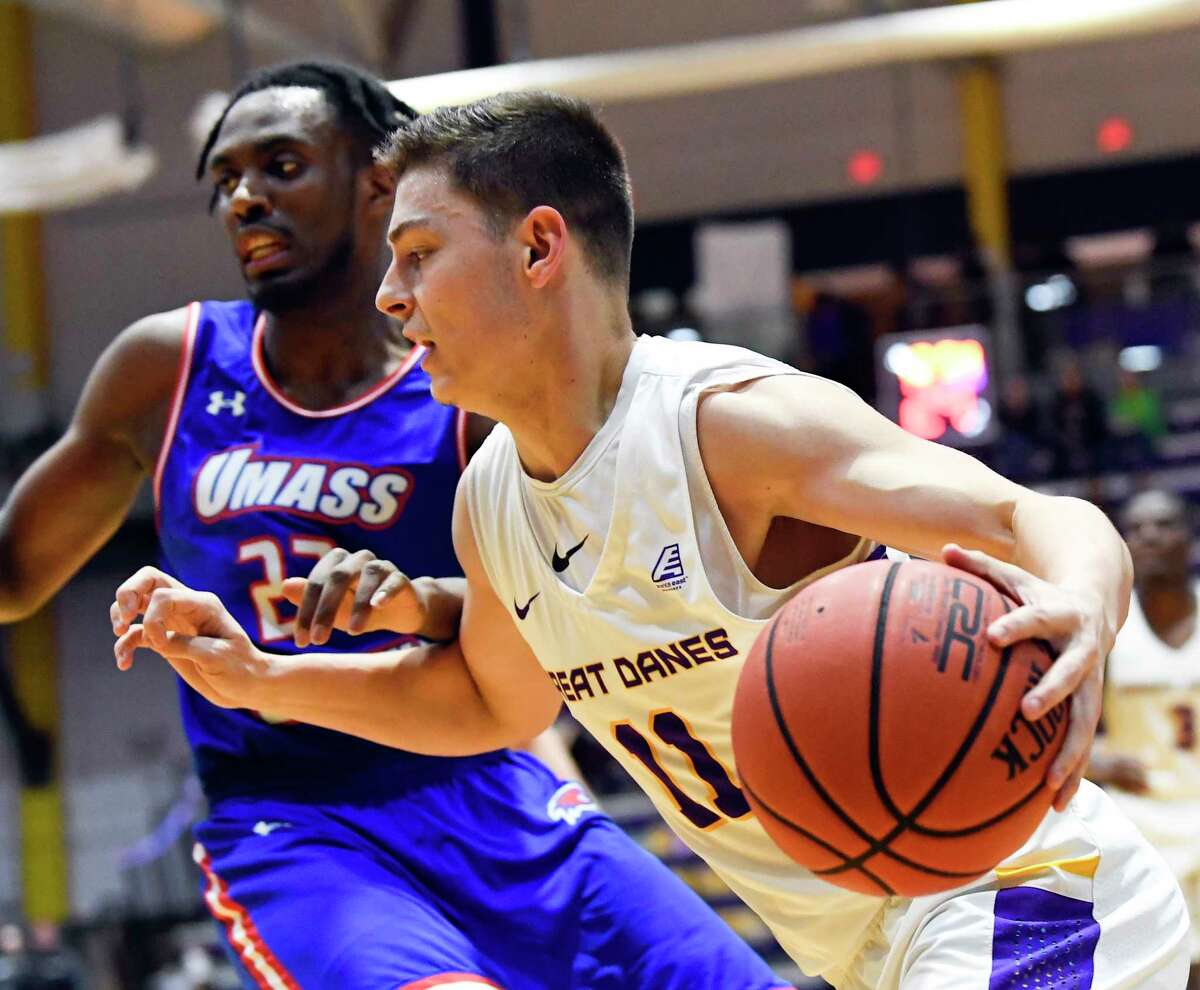 University of Massachusetts guard Christian Lutete (23) defends against University at Albany guard Cameron Healy (11) during the first half of an NCAA men's college basketball game Wednesday, Feb. 13, 2019, in Albany, N.Y. (Hans Pennink / Special to the Times Union)