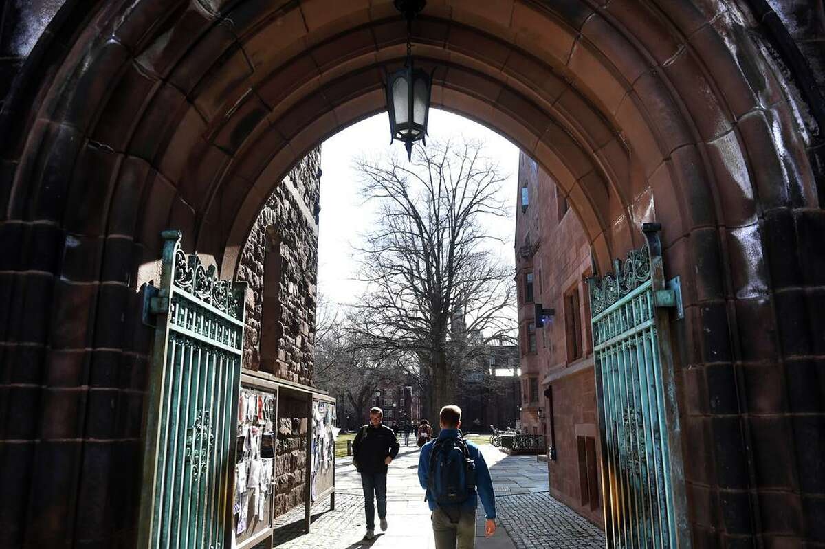 Students walk through an entrance to Yale University's Old Campus in New Haven in March 2020.