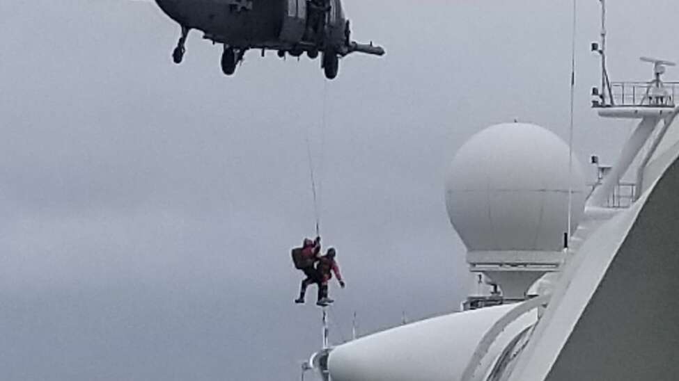 In this photo provided by Michele Smith, a California Air National Guard helicopter delivering virus testing kits lowers crew down to the Grand Princess cruise ship Thursday, March 5, 2020, off the California coast. Scrambling to keep the coronavirus at bay, officials ordered a cruise ship with about 3,500 people aboard to hold off the California coast Thursday until passengers and crew could be tested, after a traveler from its previous voyage died and at least one other became infected. Princess Cruises says fewer than 100 of those aboard have been identified for testing. (Michele Smith via AP)