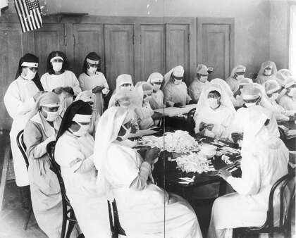 Health Volunteers in Oakland sew masks to prevent the spread of the flu, during the deadly Spanish influenza of 1918 and 1919.