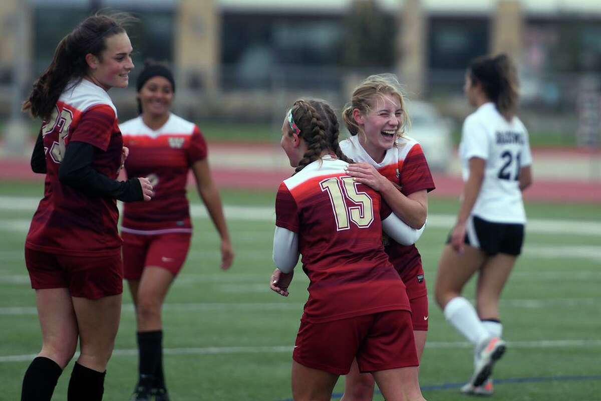 Cy Woods soccer players celebrate a goal during a District 14-6A matchup. The Lady Wildcats are one of the top teams in the 14-6A standings under head coach under Amy Trocquet.