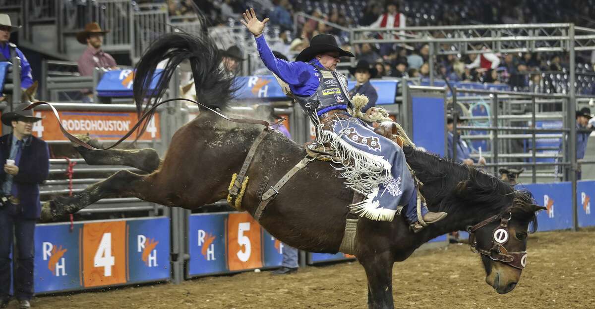 Rusty Wright competes in the saddle bronc riding event at the Houston Livestock Show and Rodeo on Thursday, March 5, 2020, at NRG Stadium in Houston.
