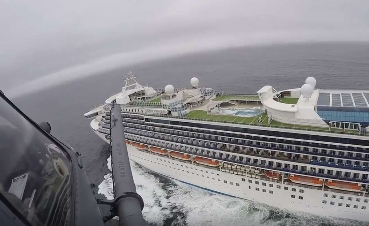 In this image from video, provided by the California National Guard, a helicopter carrying airmen with the 129th Rescue Wing flies over the Grand Princess cruise ship off the coast of California Thursday, March 5, 2020.