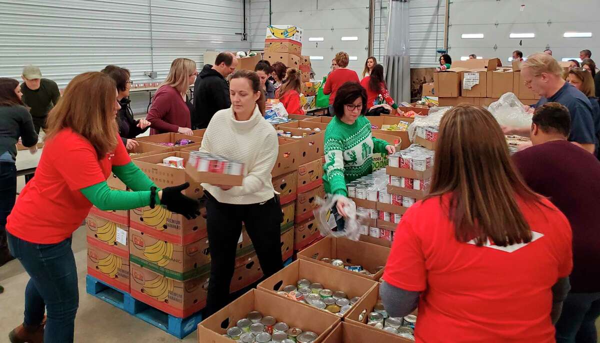Volunteers from Dow Chemical's Legal team packaging food boxes for distribution. (Photo provided)