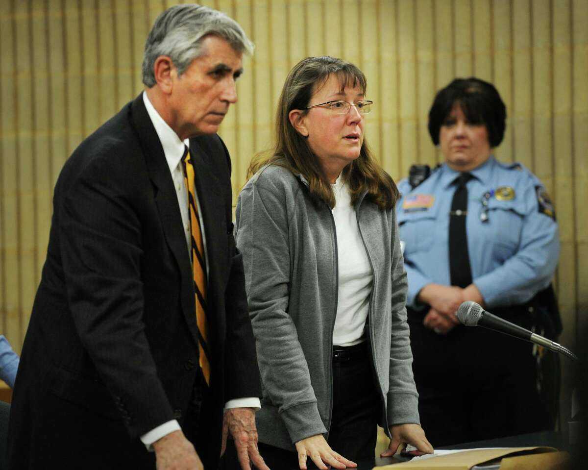 Sharon Scanlon, former assistant finance director for Shelton, stands with her lawyer, William Dow, to hear her sentence at Milford Superior Court in Milford, Conn. on Thursday, January 30, 2014. Scanlon received a 12-year sentence, suspended after 4.5 years, on larceny and forgery charges.