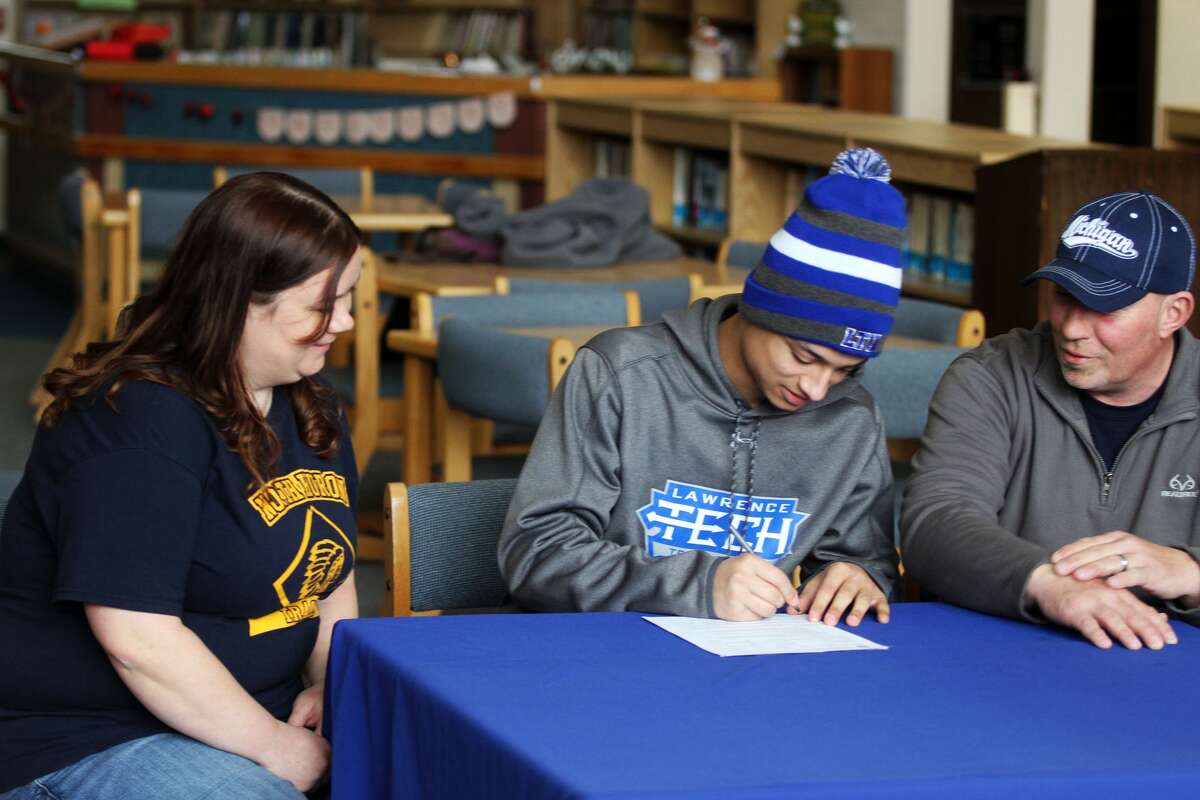 North Huron senior De'Andre Morris signed his letter of intent to run cross country at Lawrence Technical University on Friday, March 6.